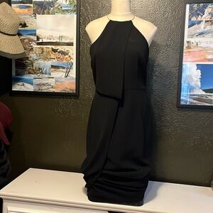 Black, knee length pencil dress. Metal halter collar